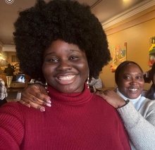 Two happy women take a selfie in a coffee shop